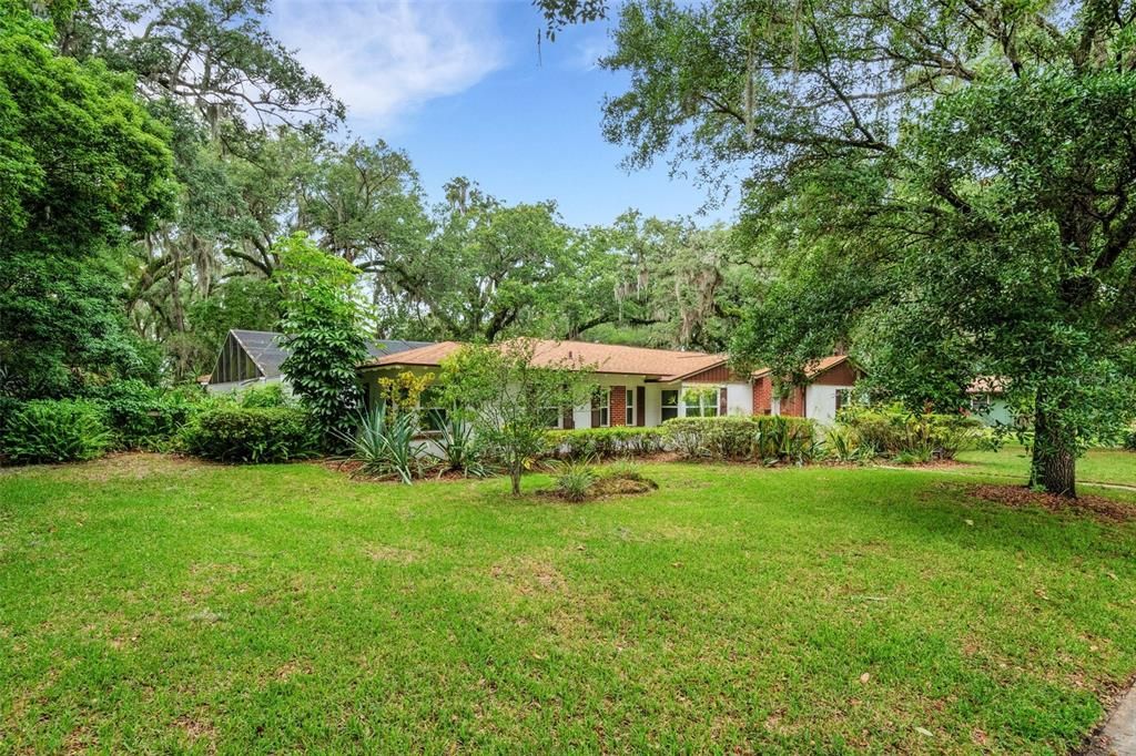 Situated on a 1/2-acre tree shrouded corner lot in central Lakeland