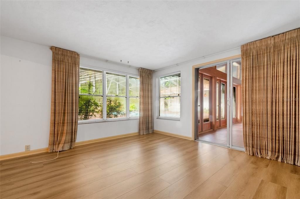 Adjacent to the dining room is the den/flex space that overlooks the courtyard pool