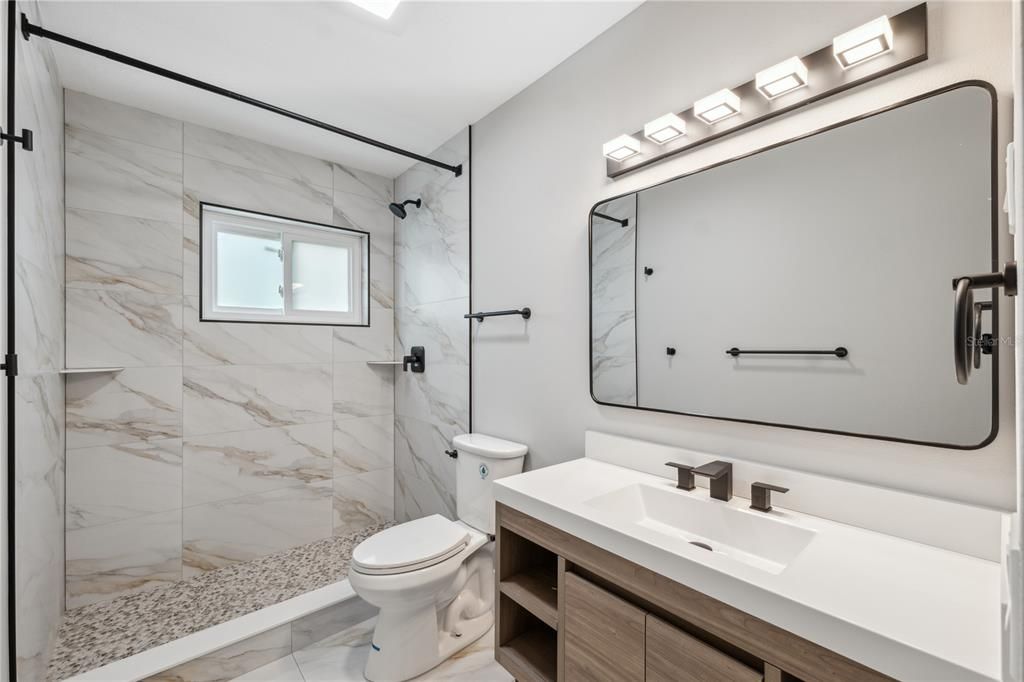 Huge walk in shower with beautifully updated finishes off the primary bedroom