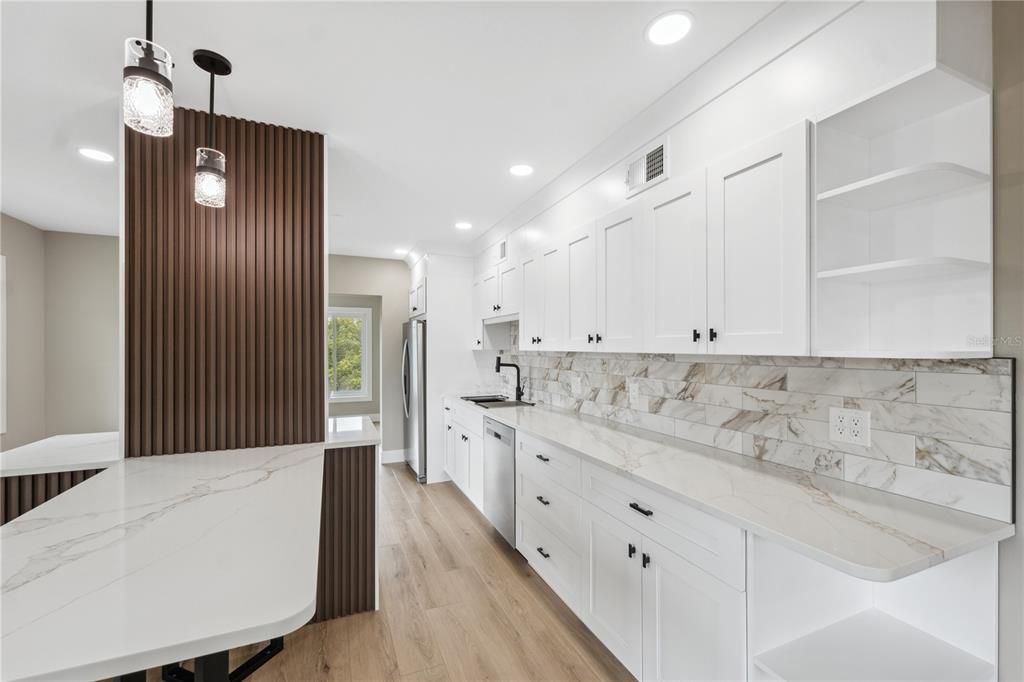 Beautiful remodeled kitchen with all new appliances , loads of cupboards  and a designer island for stools