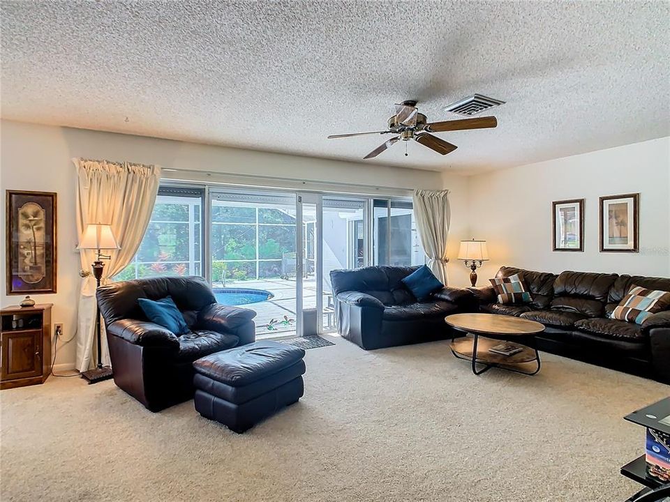 Family room has sliding glass doors that open to the pool/patio lanai area.