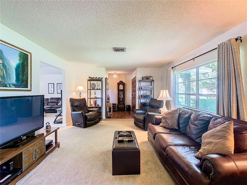 Formal living room is located in the front of the home with lots of windows providing plenty of natural light into the home