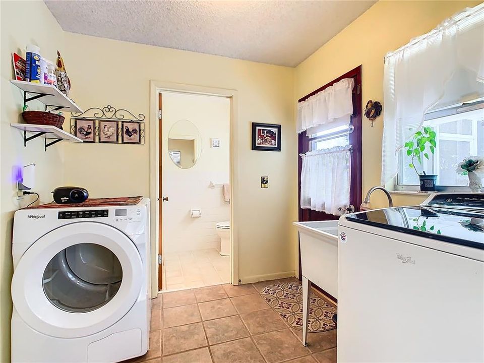 Utility room and the back door leads to the pool and patio