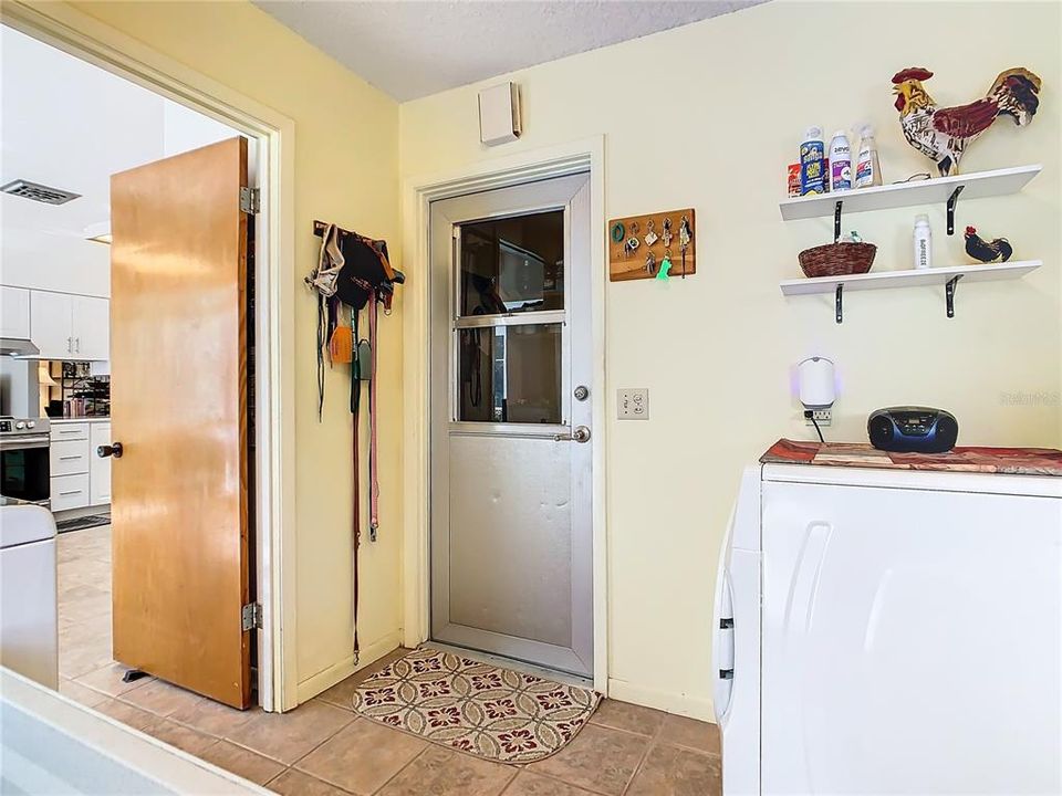 Utility room is off the kitchen and leads to the garage.