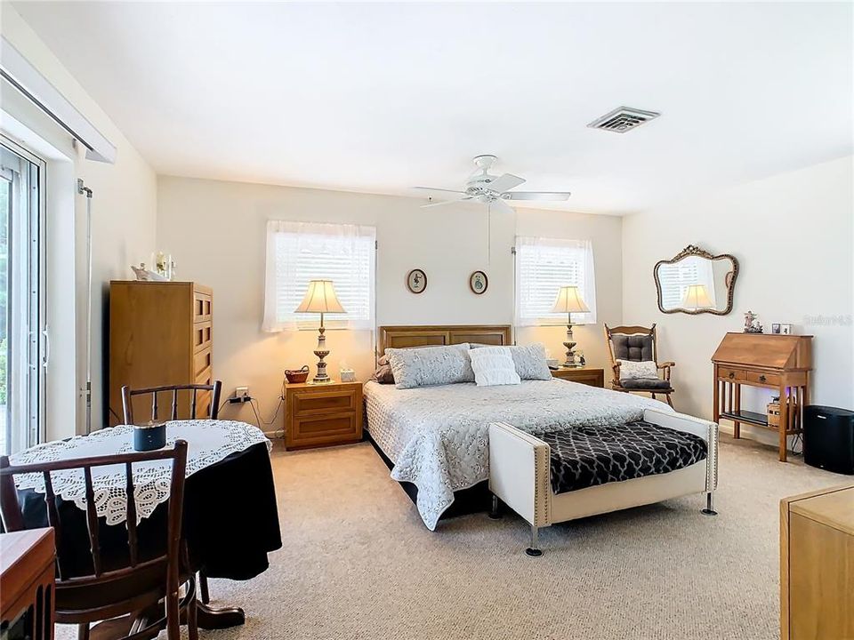 Master bedroom has a sliding glass door to the pool patio and lanai area.