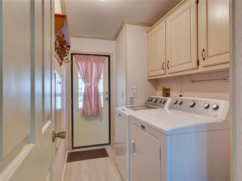 Inside laundry Room with Cabinets