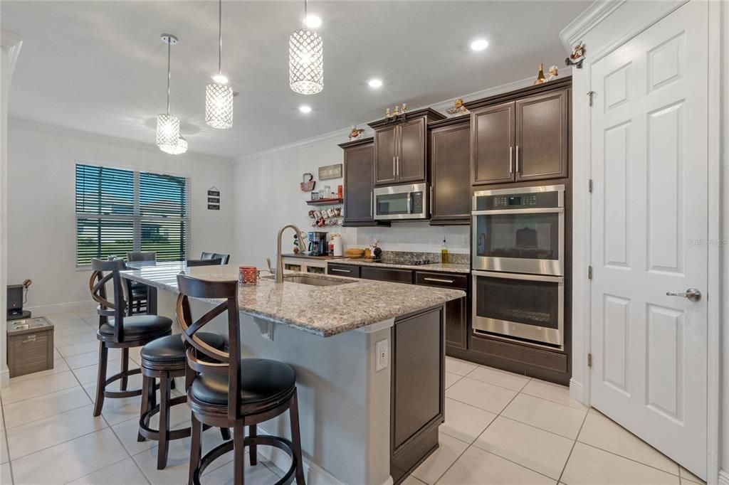 A chef's delight! This gourmet kitchen features high-end appliances, granite countertops, and ample cabinet space, perfect for culinary creations and entertaining guests.