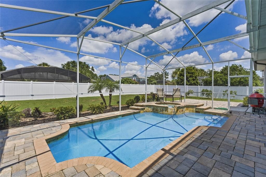 The COVERED LANAI is the perfect place to relax poolside with space for outdoor living and dining overlooking a HEATED POOL and SPA, all SCREENED for maximum comfort.