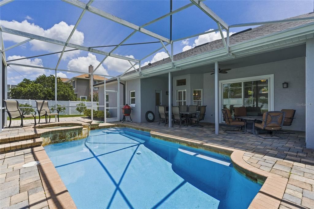 The COVERED LANAI is the perfect place to relax poolside with space for outdoor living and dining overlooking a HEATED POOL and SPA, all SCREENED for maximum comfort.