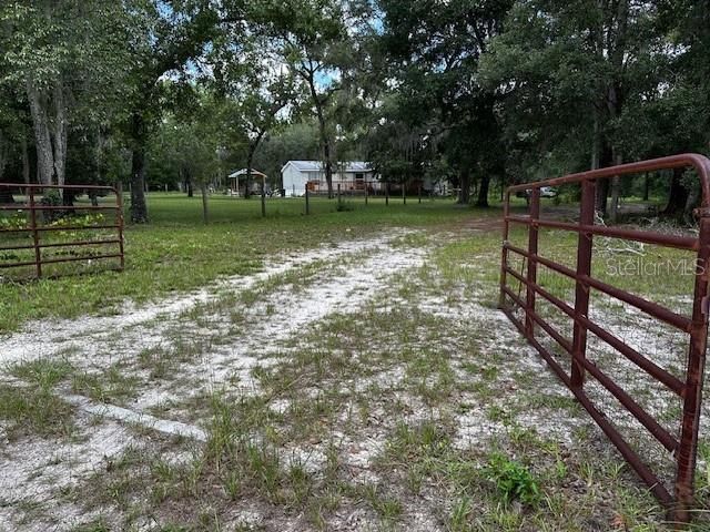 Double gate to residence off main roadway