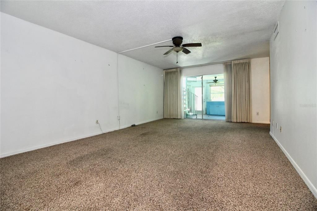 LIVING ROOM WITH SLIDERS TO ENCLOSED PATIO