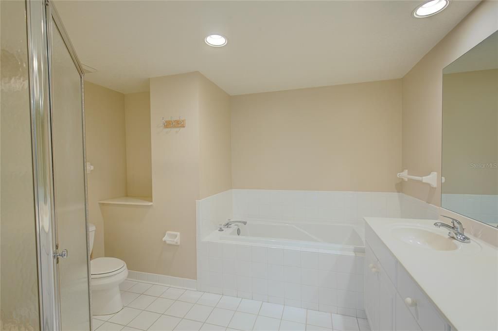Master bath includes dual sinks, a large walk-in shower and a bathtub.
