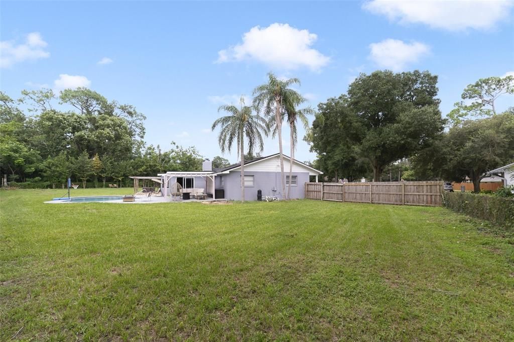 The over half an acre lot includes a fenced backyard where you can spend the Summer poolside and the mature trees around the perimeter add privacy.