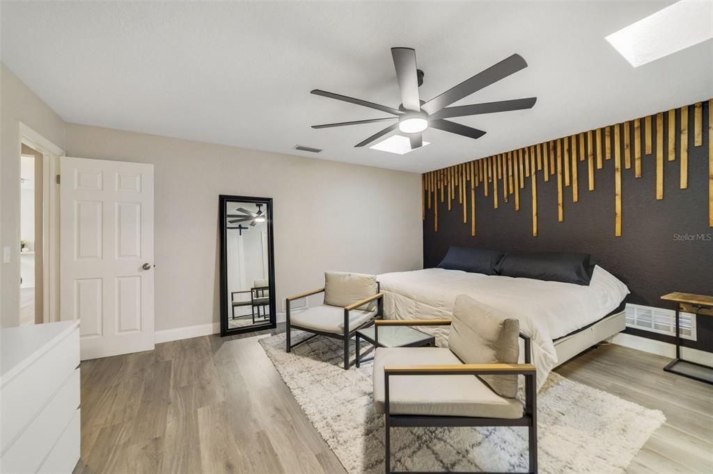 Ideal SPLIT BEDROOMS deliver a must see PRIMARY SUITE with a chic accent wall, more skylights, WALK-IN CLOSET with a CUSTOM STORAGE SYSTEM and a completely updated private en-suite bath.