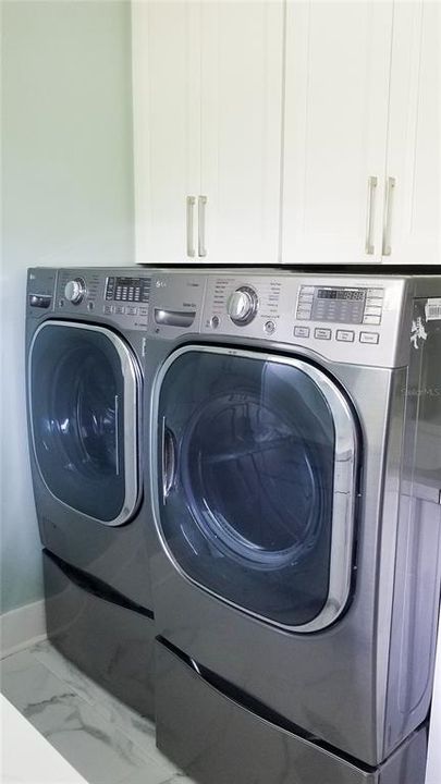 Laundry room with lots of cabinets for storage