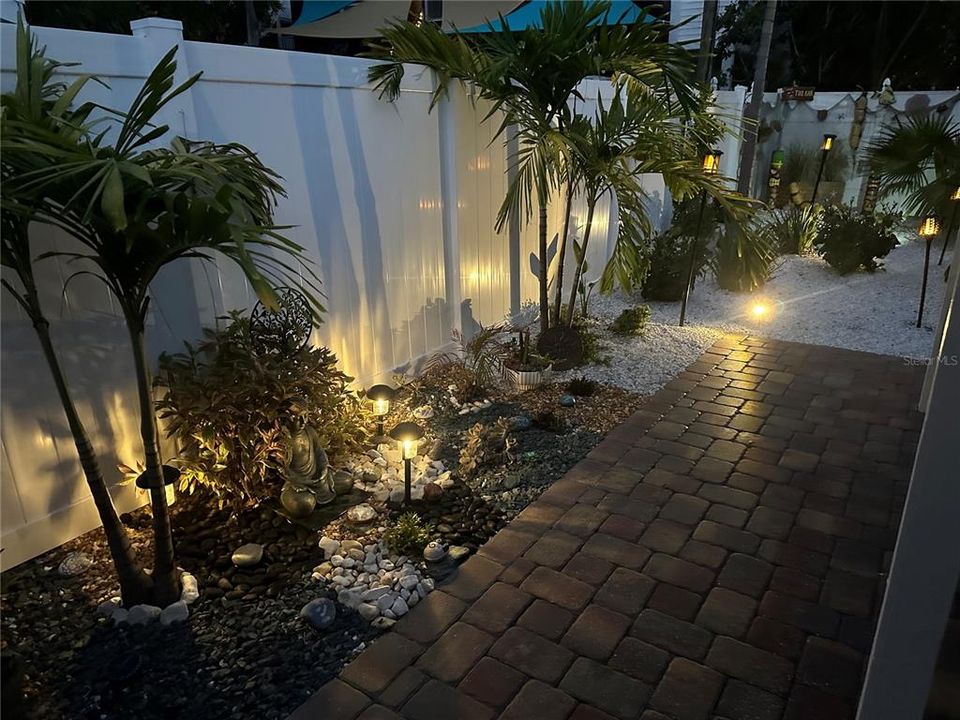Rear yard landscaping lights during evening