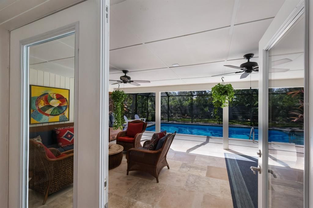 The covered lanai features travertine decking and two ceiling fans, keeping you cool under cover on those hot summer days.