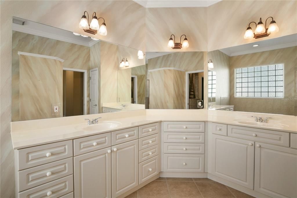 Primary bath has a double vanity wall with lots of storage.