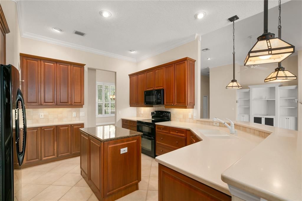 Warm wood cabinets and bar top seating.