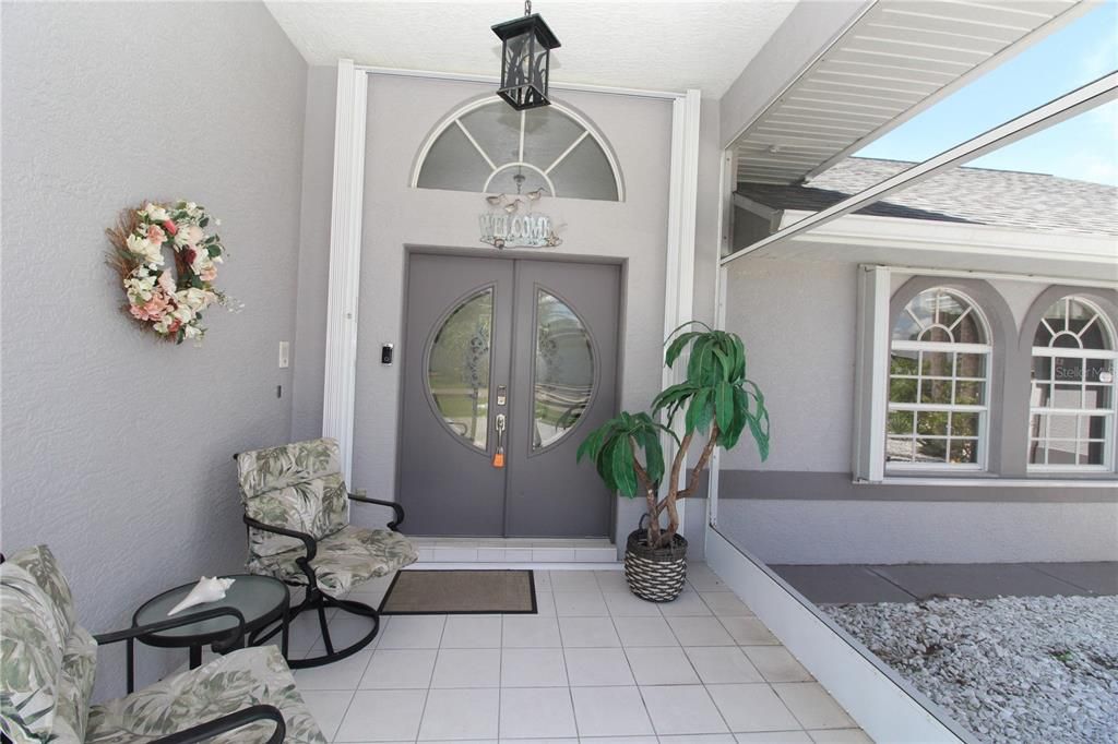Spacious Front Porch.... Decorative etched glass double door entry....with transom window for extra lighting inside....
