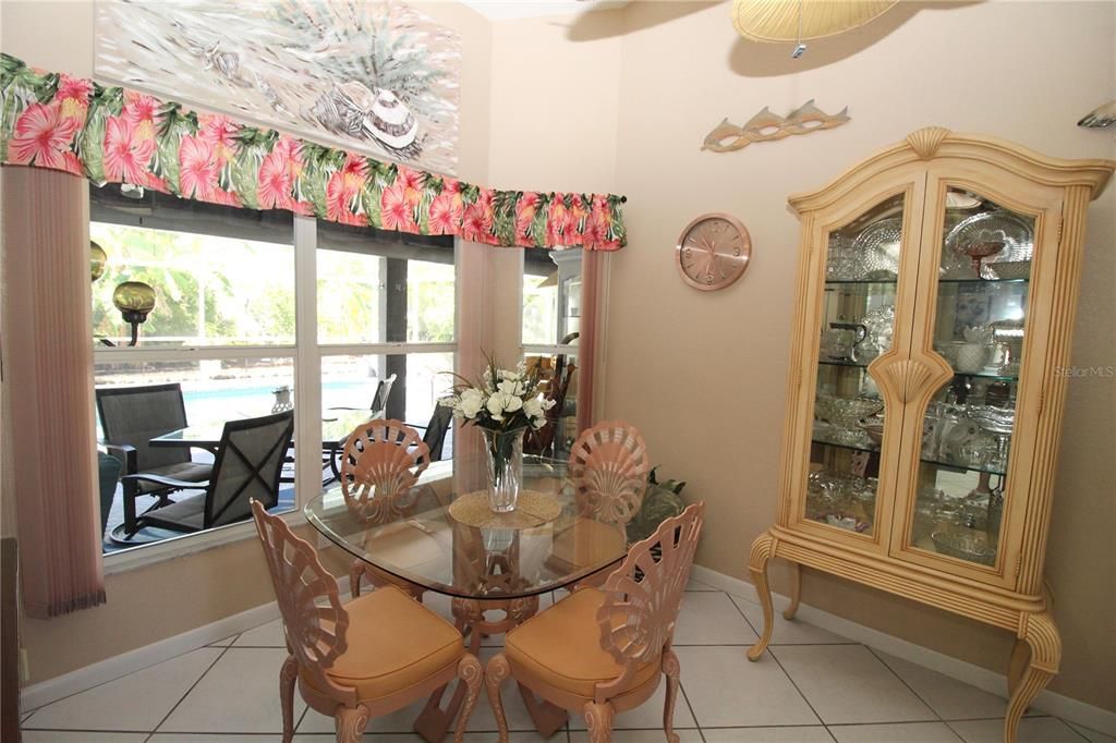 Formal Dining room with bay window looking out into the lanai and sparkling pool....