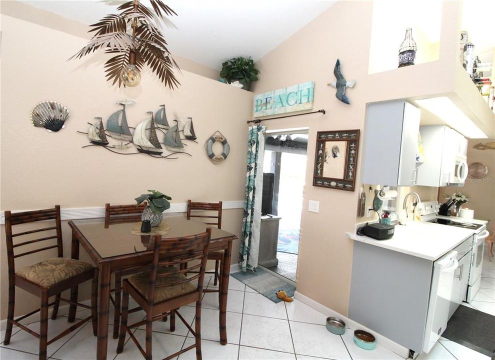 Dinette Area with pocket sliding glass door out to the lanai/pool.  Really cool light fixture...