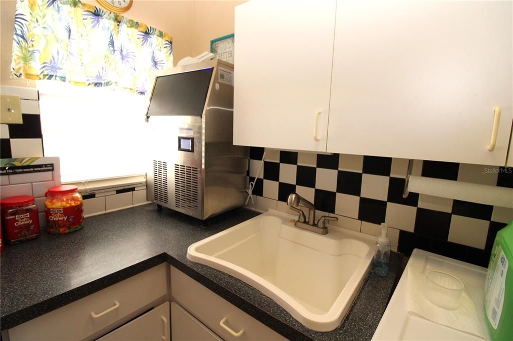 Laundry room..... deep utility sink...built-in cabinets....