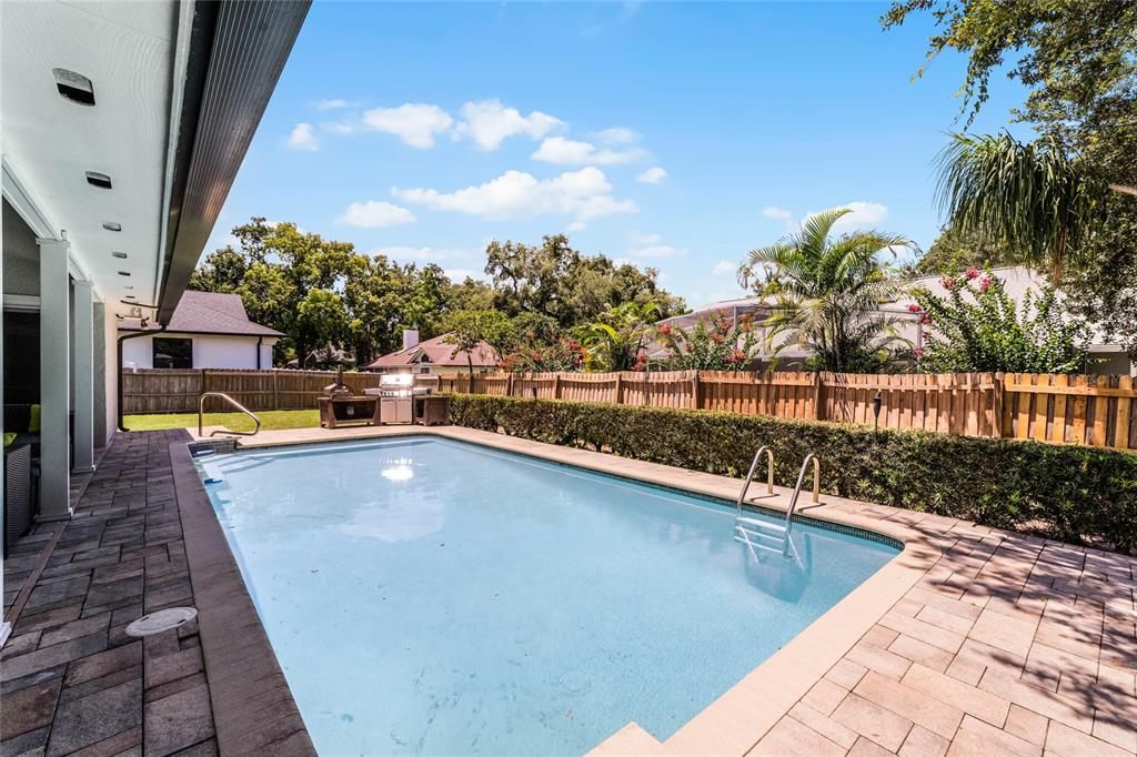 newly resurfaced pool and large fenced backyard