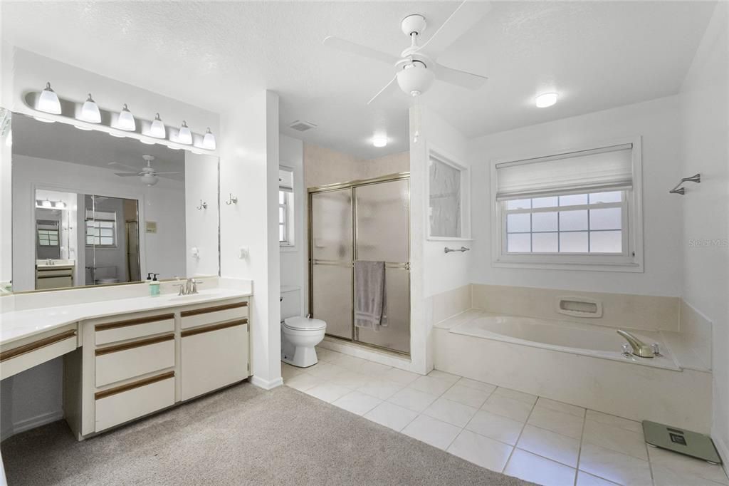 primary bath with enclosed shower, and tub