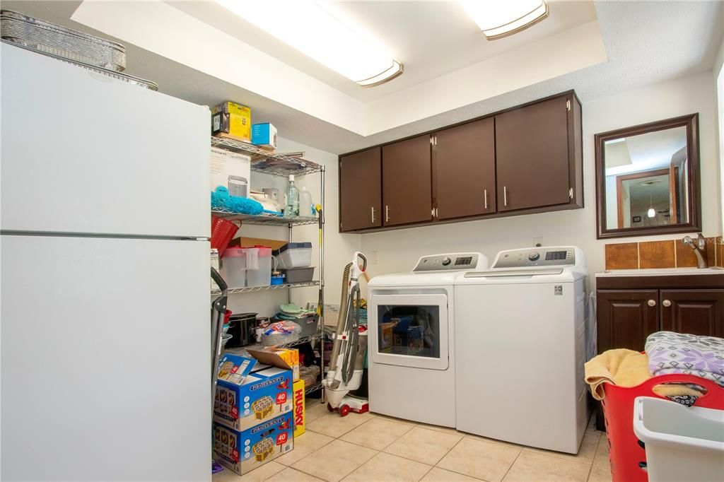 Laundry room with storage. Door that leads to pool is to the right of the picture