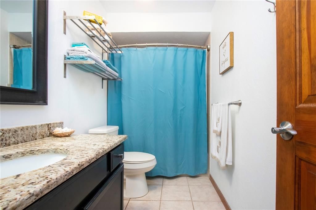 Updated guest bathroom with granite countertops and new toilet