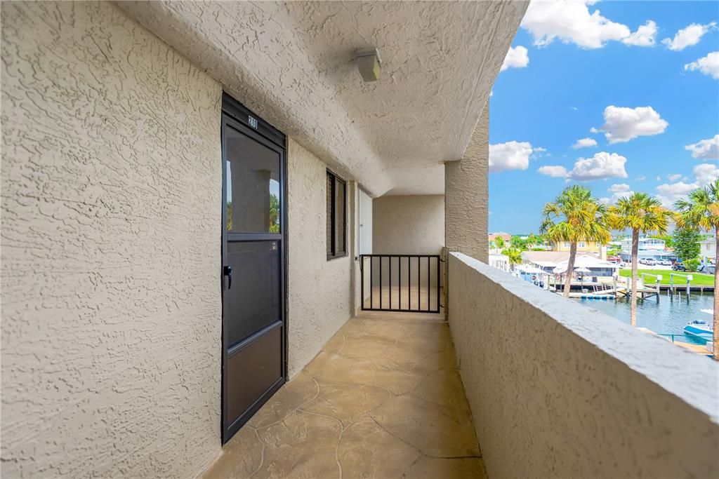 Walk way to unit from elevator.  Notice to right the water view and boat slips.