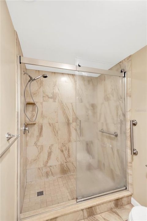 Easy care tile shower with double glass doors.