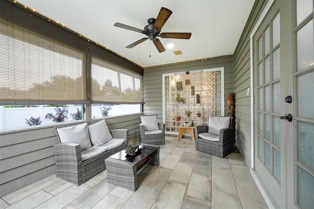 Lanai Tiled and re-screened. Window covering new ceiling fan.