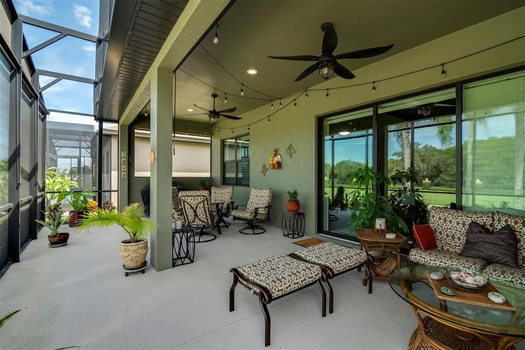 Covered part of lanai with canned lighting and ceiling fan