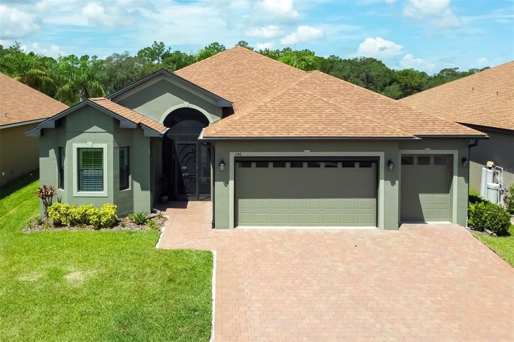 Front of home with 2 car garage and screened in front porch