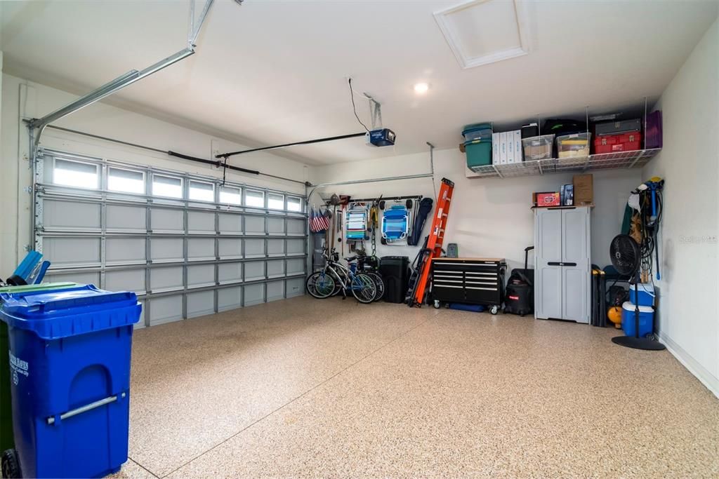 Large garage with epoxy floors and storage