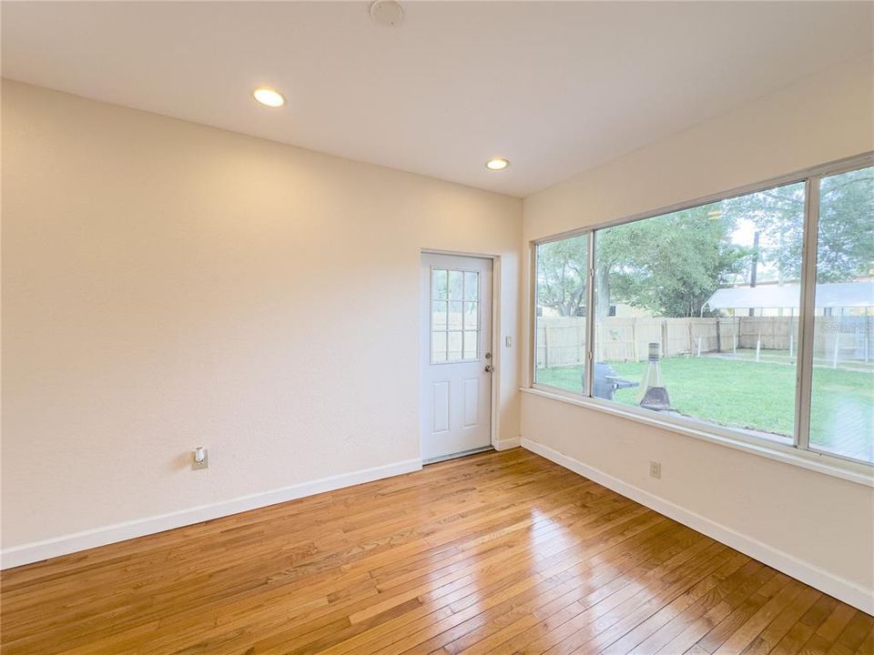 Living room with view of back yard and entrance to back outdoor patio