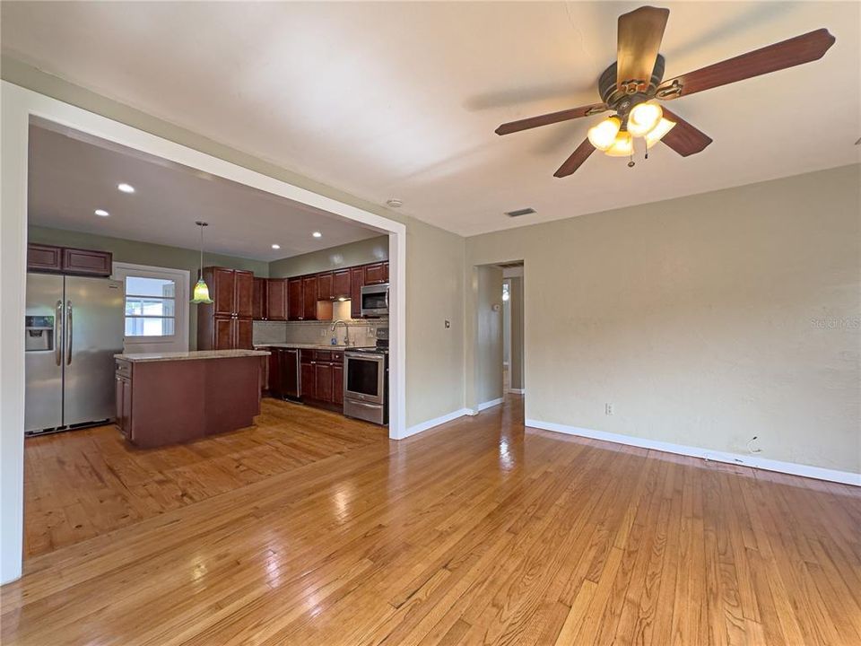 Living room with view of kitchen and hallway towards bedrooms.