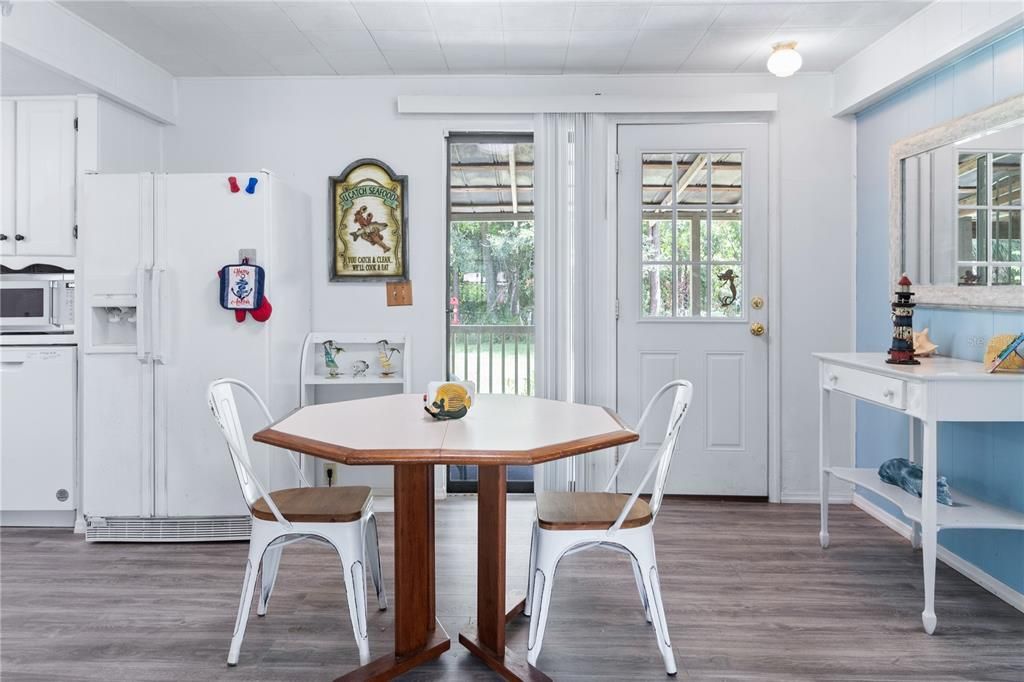 The backdoor in the dining area leads to the back porch and yard.