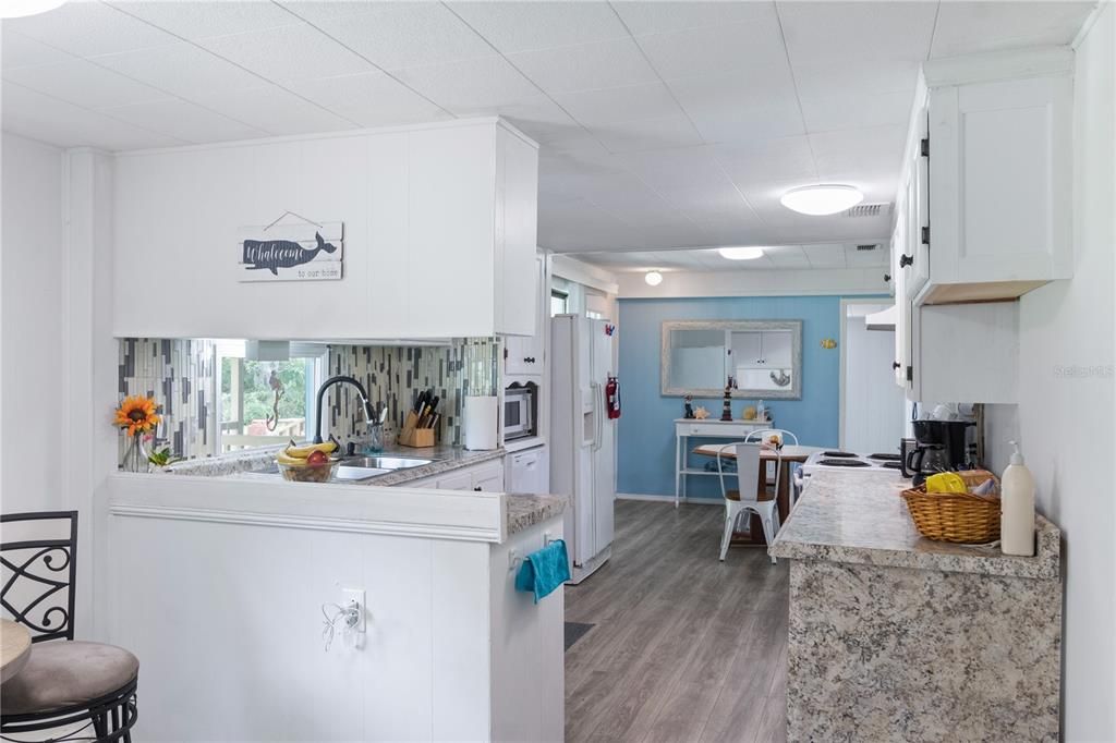 Standing in front of the breakfast nook looking at the kitchen.