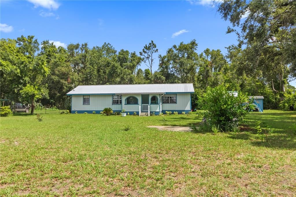 Step onto the property and take a breath as you take in the large front yard.