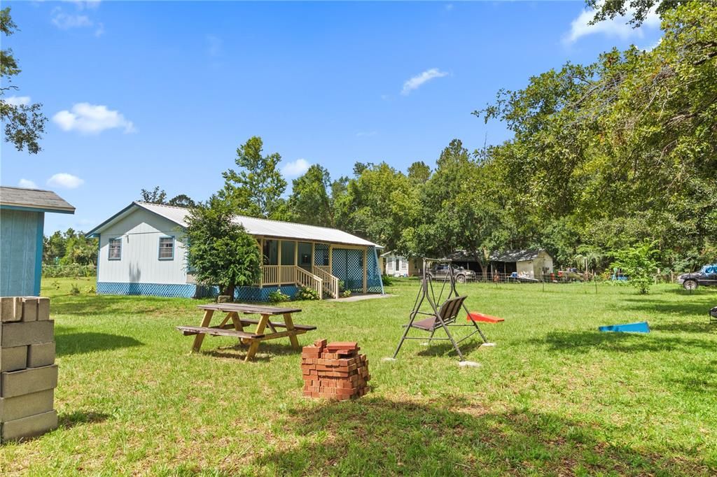 Swing set, bench, shed, ample space... This backyard provides a little more than you would think to ask for!