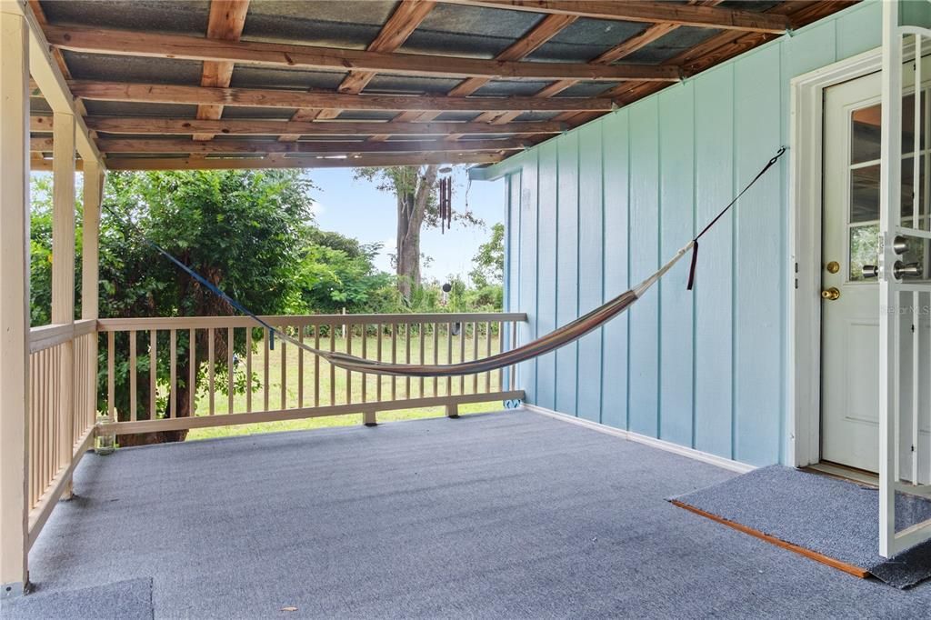 A large back porch provides seating area as desired or you can enjoy the already perfectly placed hammock!