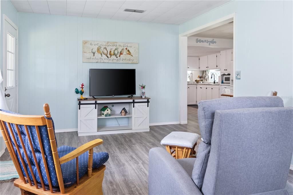 The living room leads to the dining area and kitchen.