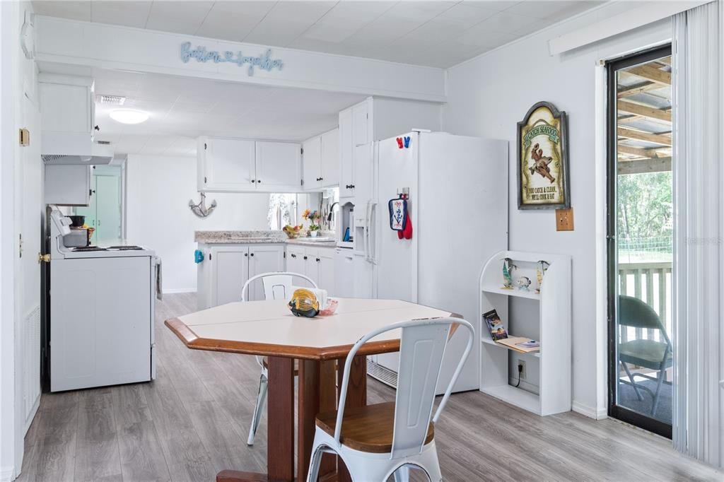 View of the kitchen standing in the dining room.