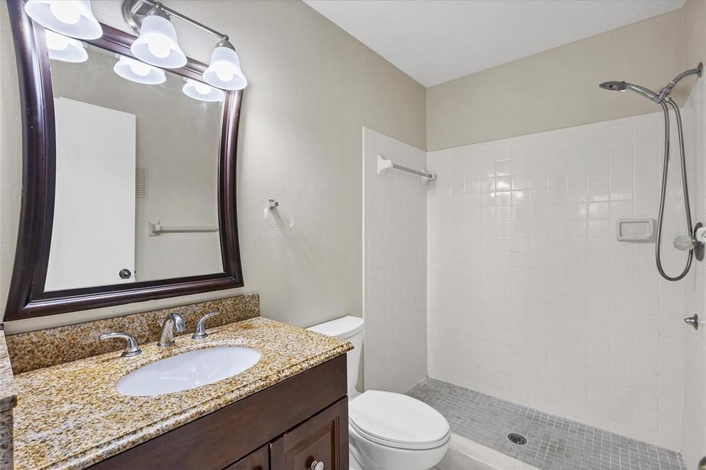 Primary bathroom with shower, vanity, toilet at 3862 59th Ave. W, Bradenton FL 34210