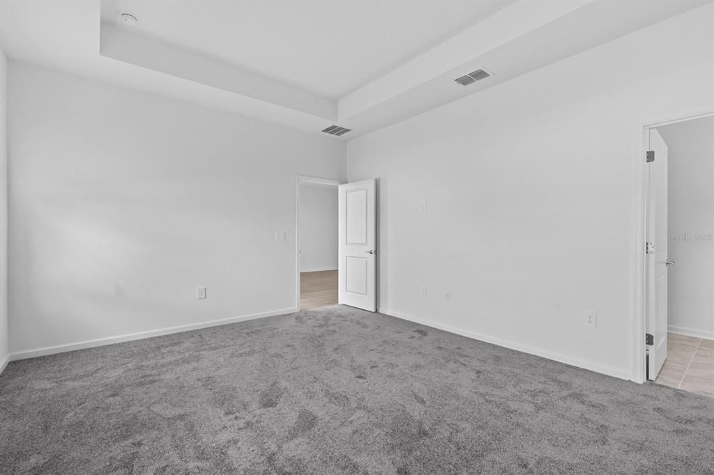 Primary Bedroom w/ view of door