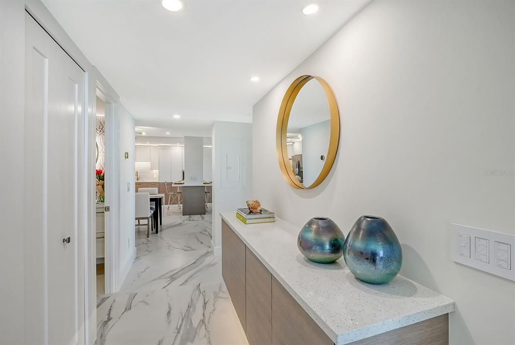 Hallway with built-in cabinet and accent lighting