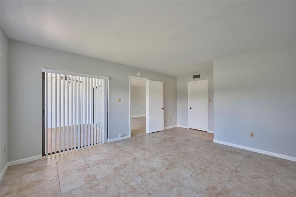 Sliding doors in the master bedroom lead to the screened lanai